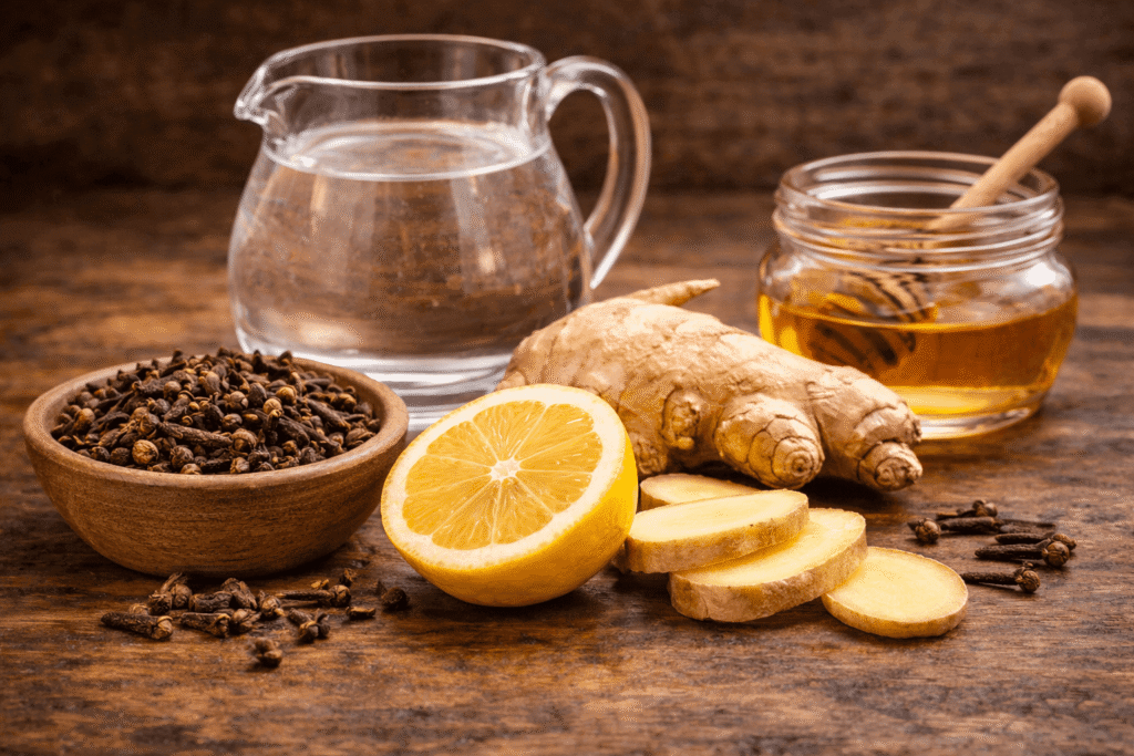 ingredients for clove water recipe whole cloves lemon ginger honey and water