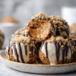 peanut butter cheesecake balls no bake dipped in dark and white chocolate with graham cracker crumbs
