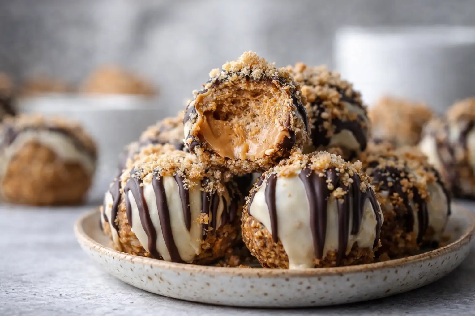 peanut butter cheesecake balls no bake dipped in dark and white chocolate with graham cracker crumbs