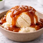 salted coconut sugar caramel sauce recipe over vanilla ice cream on white marble kitchen background