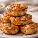 stack of cinnamon apple cottage cheese bites with honey drizzle on white plate