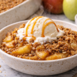 Joanna Gaines apple crisp served warm with vanilla ice cream and caramel sauce
