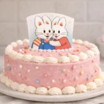 max and ruby cake decorated with pink frosting and bunny topper