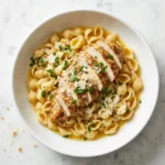 ina garten chicken with buttered noodles recipe in white bowl on marble