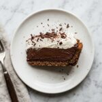 ina garten chocolate silk pie recipe whole pie with whipped cream and chocolate shavings on white marble