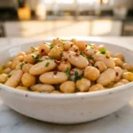High-fiber Mediterranean bean bowl with cannellini beans and fresh vegetables on marble