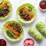 Korean BBQ cabbage wraps with ground beef on a white marble surface