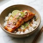 Hot honey salmon plated over coconut rice with scallions