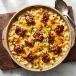 Creamy BBQ chicken mac and cheese in a rustic baking dish