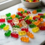 colorful Haribo Goldbears gummy bears on white marble
