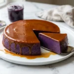 Unmolded ube leche flan with glossy caramel and a cut wedge showing the silky purple custard